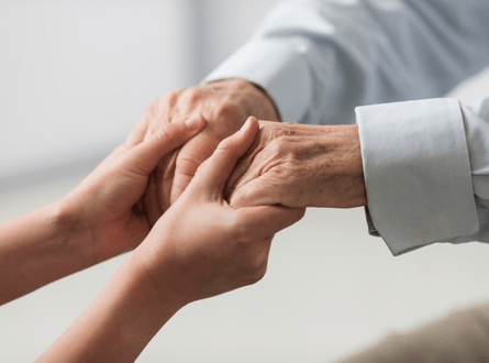 Woman Holding Old Person's Hands